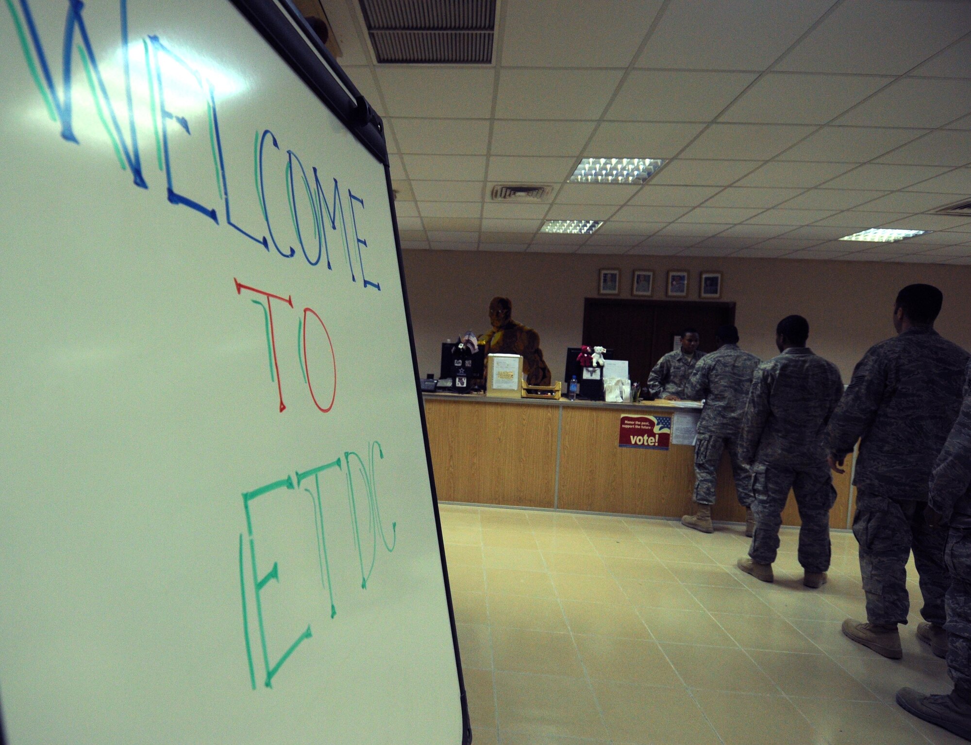 Airmen wait to sign in at the 386th Expeditionary Theater Distribution Center, a one-stop shop for individual body armor, chemical protective gear and weapons courtesy storage for forward deployers and transit members. (U.S. Air Force photo by Staff Sgt. Patrice Clarke)