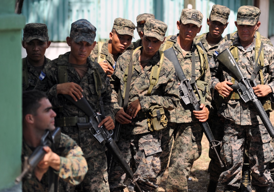 U.S. Marine Staff Sgt. Daniel Monteiro, lower left, demonstrates proper tactical movement to Honduran soldiers during a weeklong expert exchange to support Southern Partnership Station in San Lorenzo, Honduras, March 15, 2011. The annual exercise deploys U.S. ships to the U.S. Southern Command area of responsibility in the Caribbean and Latin America to share information with navies, coast guards and civilian services throughout the region. The Honduran soldiers are assigned to Marine Corps Training and Advisory Group.
