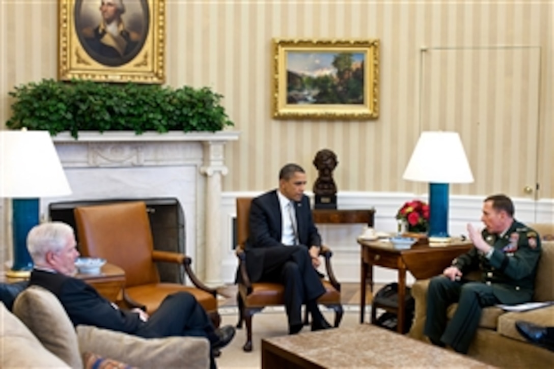 President Barack Obama meets with Defense Secretary Robert M. Gates and Army Gen. David H. Petraeus, commander of NATO and U.S. Forces in Afghanistan, in the Oval Office at the White House in Washington, D.C., March 14, 2011.