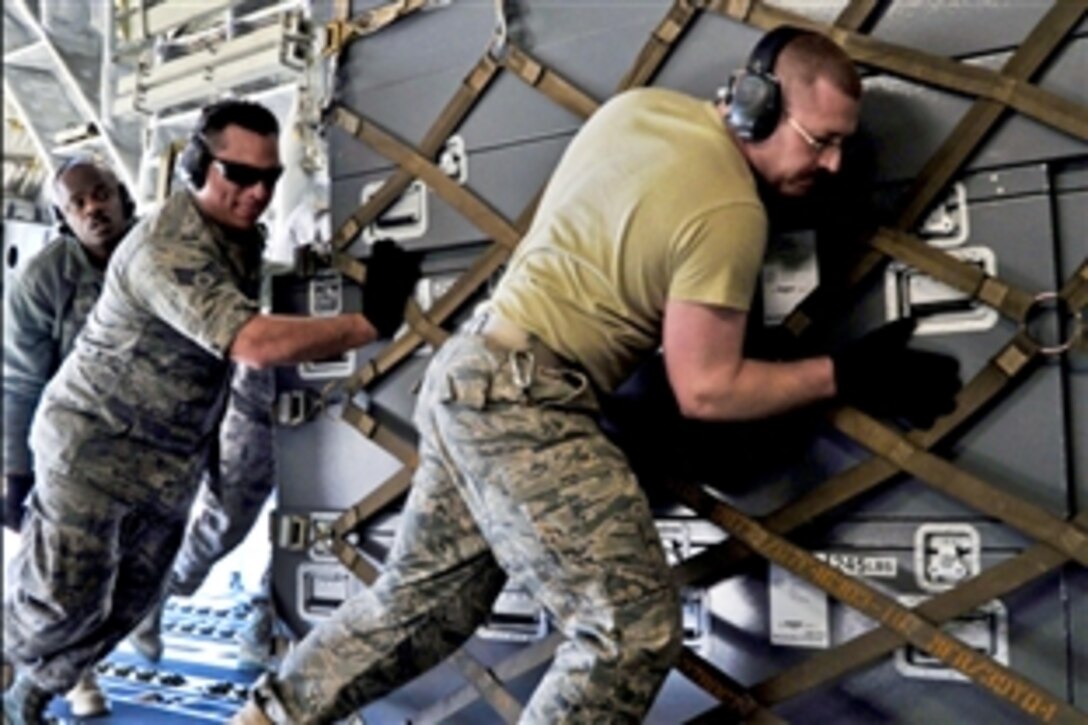 U.S. Air Force airmen load pallets of gear onto a C-17 Globemaster III on Joint Base Andrews, Md., March 12, 2011. The air transportation airmen from the 89th Aerial Port Squadron created 14 pallets of technical search and rescue gear, including inflatable swift-water rescue boats, generators, trench rescue and cutting equipment to support earthquake relief in Japan.