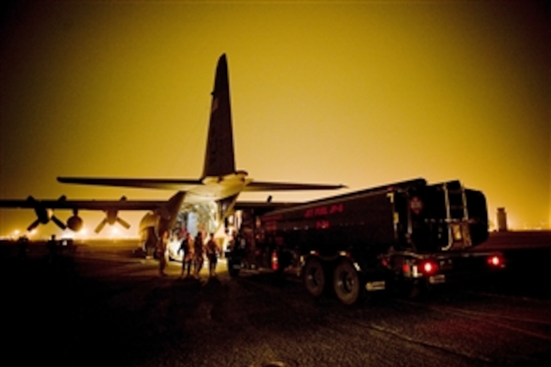 A fuels truck pulls up to a C-130H Hercules aircraft to be loaded on March 15, 2011.  The fuels truck will be taken to Yamagota Airport to support Japan's earthquake and tsunami relief efforts.  