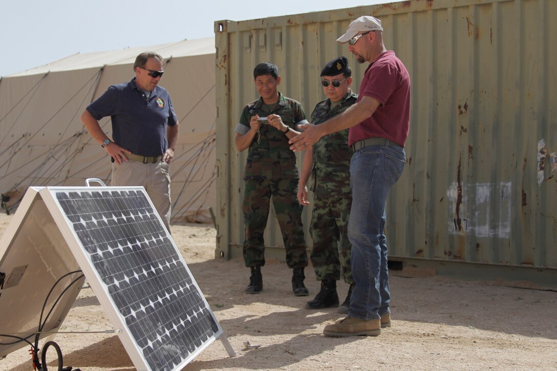 Members of the Combat Center’s Western Area Research Test and Evaluation Center show Lieutenant Gen. Surapun Wongthai and Rear Admiral Sanyalak Rungsampan new equipment being tested March 18, 2011, at Camp Wilson.::r::::n::