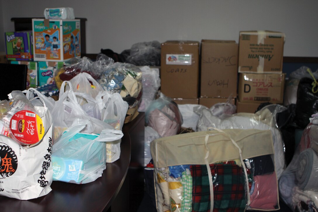 Blankets, coats, food and other items fill the Camp Foster Navy Federal Credit Union branch office March 18. The NFCU team chose to store items here until they can be shipped to mainland Japan to help in the humanitarian assistance and disaster relief efforts.