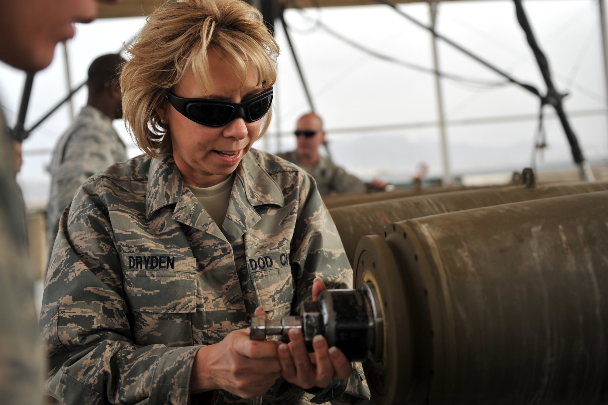 Ms. Sue Dryden, 309th Maintenance Wing director, installs tail fuse during her visit at the ammunition supply point at Bagram Airfield, Afghanistan, March 18, 2011. Ms. Dryden received hands-on training on how to build a live bomb. (U.S. Air Force photo by Senior Airman Sheila deVera)