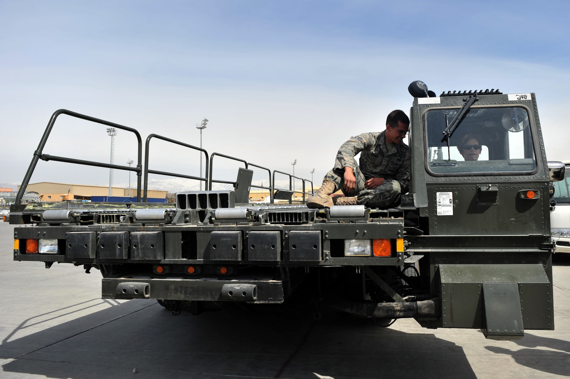 Maj. Gen. Kathleen Close, Air Force Materiel Command Director of Logistics and Sustainment, gets hands-on training from Senior Airman Brennan McGinley on how to operate a K-loader at Bagram Airfield, Afghanistan, March 18, 2011.  General Close met and talked to deployed Airmen to determine how the comand can better accomplish its supply and sustainment operations. (U.S. Air Force photo by Senior Airman Sheila deVera)