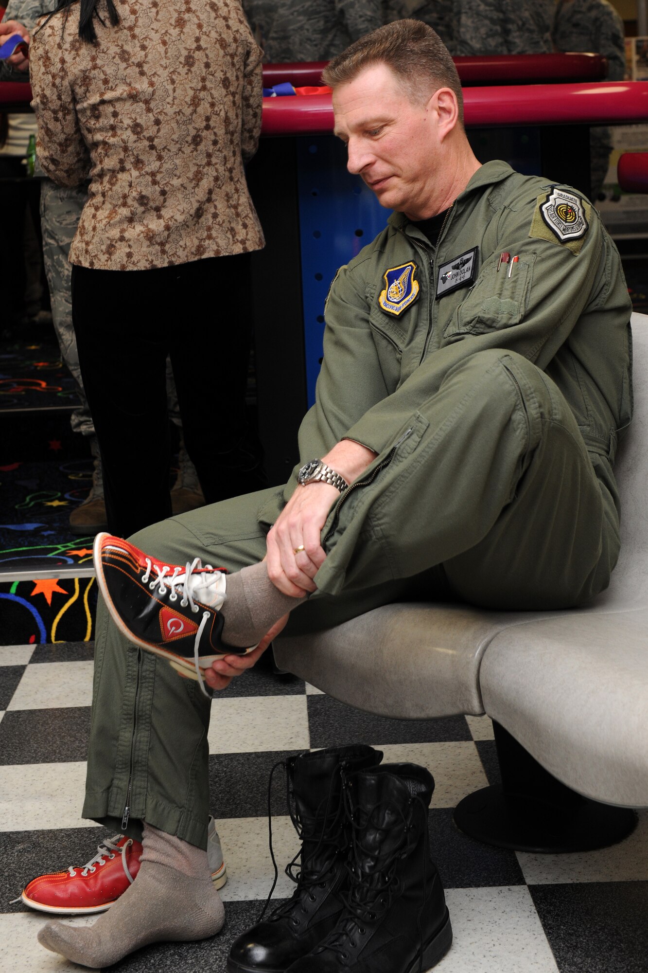 KUNSAN AIR BASE, Republic of Korea -- Col. John Dolan, 8th Fighter Wing commander, readies his bowling shoes before throwing out the first ball at the grand opening of the Take It North bowling center.  The bowling center had been shut down for months while repairs were made to fix a collapsed roof.  (U.S. Air Force photo/Tech. Sgt. Jonathan Pomeroy) 
