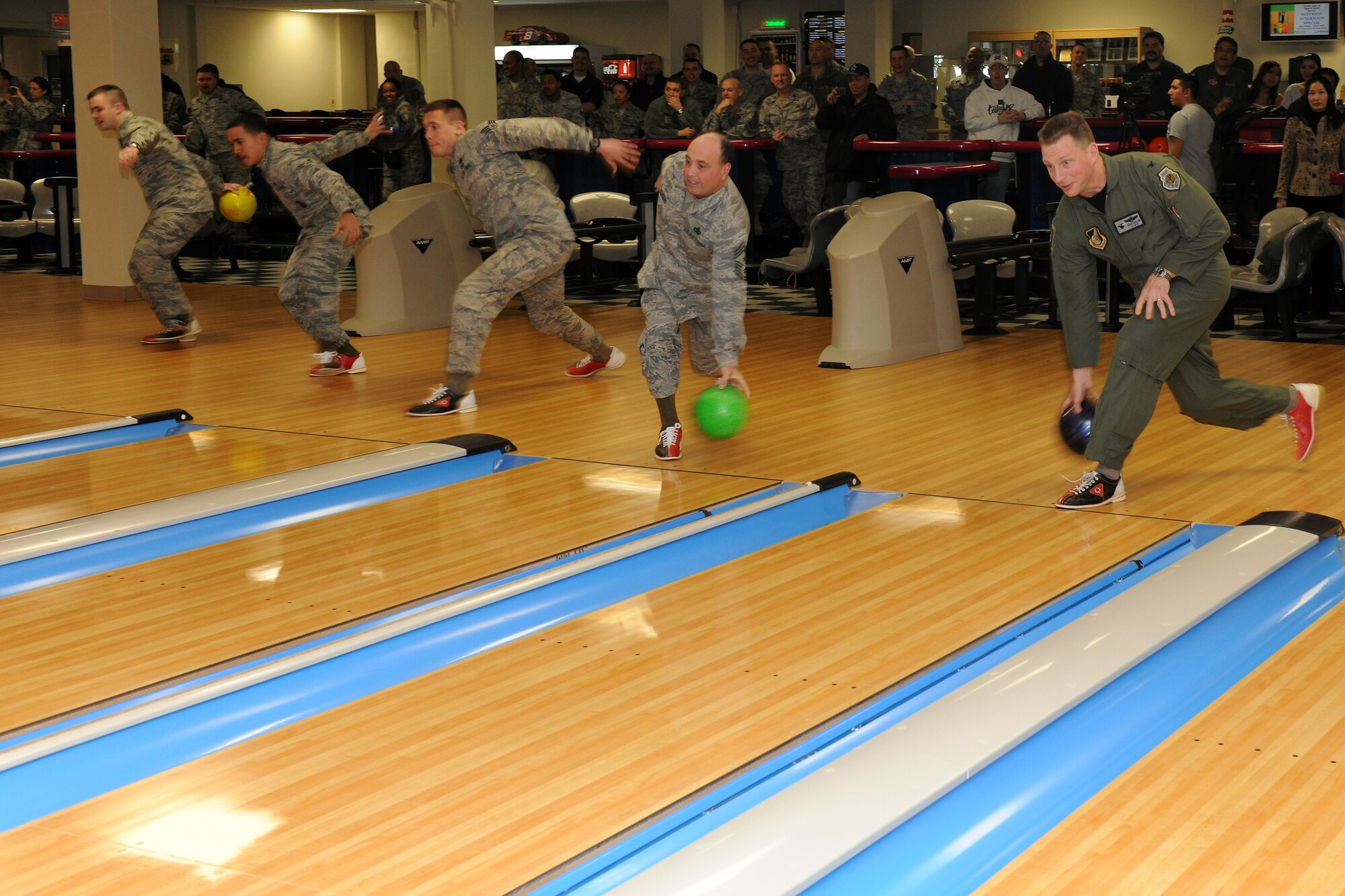 KUNSAN AIR BASE, Republic of Korea -- Col. John Dolan, 8th Fighter Wing commander, leads bowlers in launching the first bowling balls down the lanes at the same time at the grand opening of the Take It North bowling center.  The bowling center had been shut down for months while repairs were made to fix a collapsed roof.  (U.S. Air Force photo/Tech. Sgt. Jonathan Pomeroy) 
