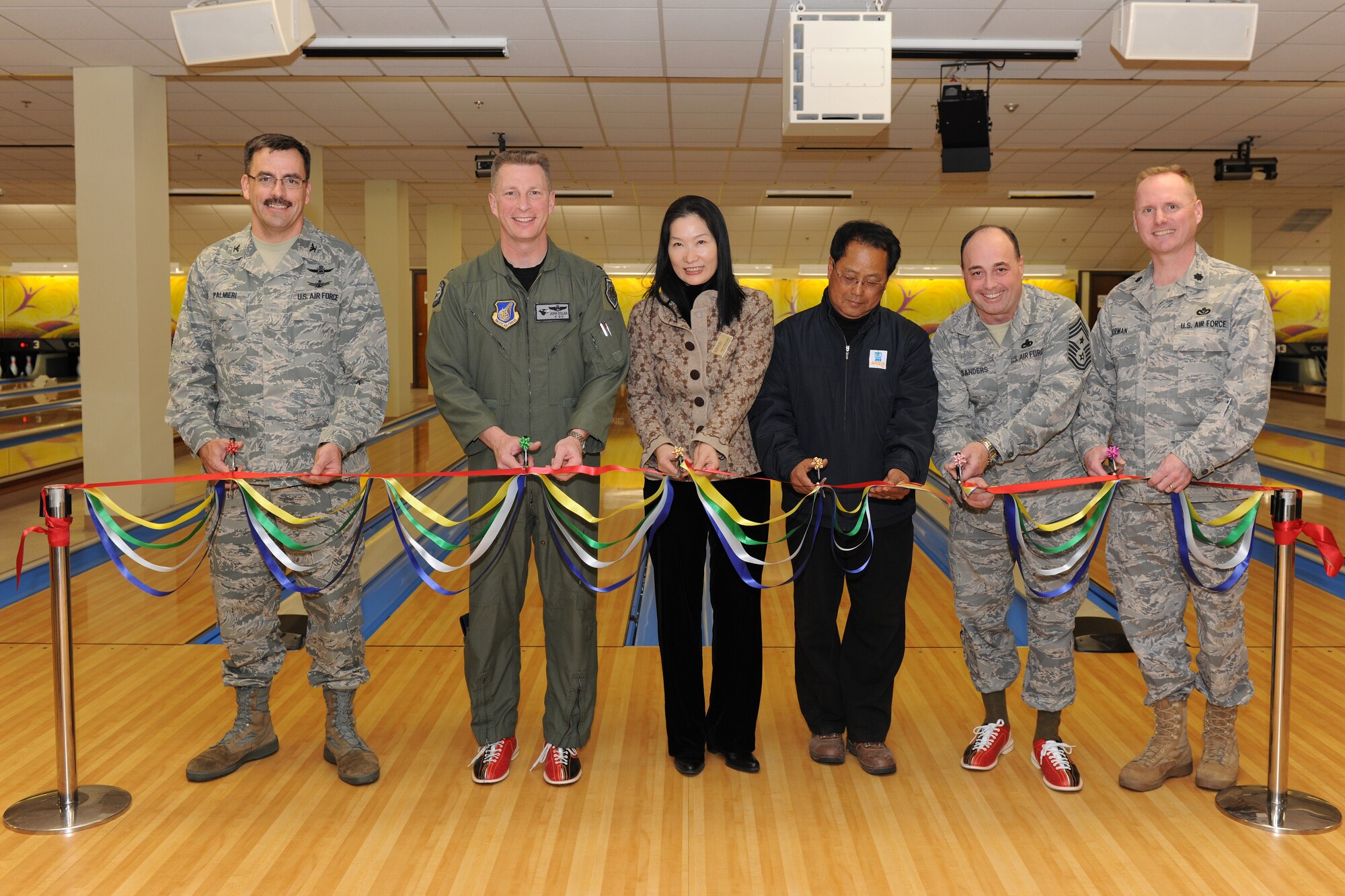 KUNSAN AIR BASE, Republic of Korea -- Col. John Dolan, 8th Fighter Wing commander, leads the ribbon cutting ceremony at the grand opening of the Take It North bowling center.  The bowling center had been shut down for months while repairs were made to fix a collapsed roof.  (U.S. Air Force photo/Tech. Sgt. Jonathan Pomeroy) 
