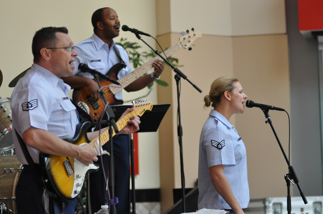 Top Flight performed at the Desert Sky Mall in Phoenix, AZ on March 15 in support of Air Force Recruiting.  Pictured:  SrA Courtney Clifford, lead vocals; SSgt Greg Lacy, guitar and background vocals; SrA Henry Roberson, bass and background vocals.