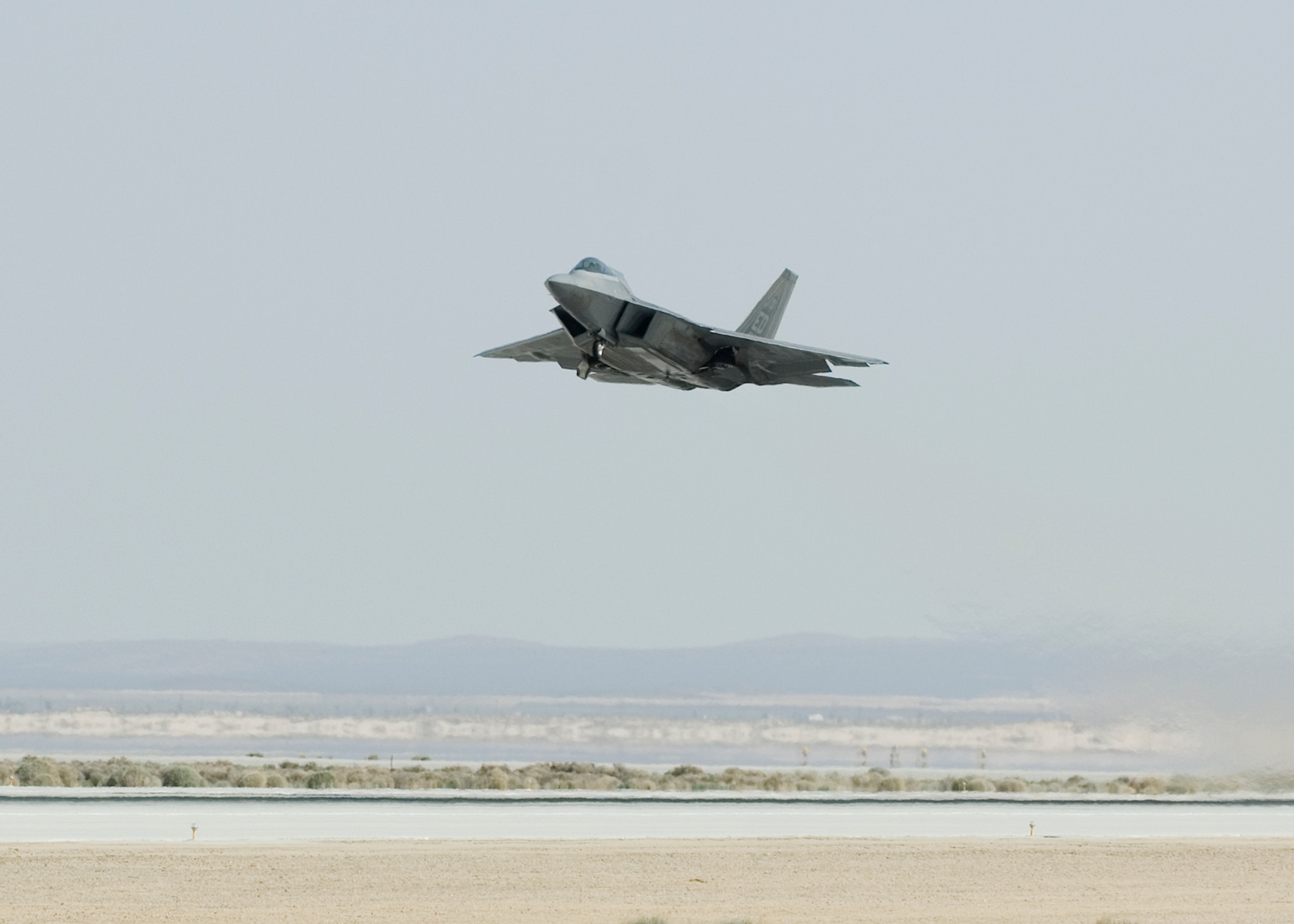 An F-22 Raptor takes off at Edwards powered by biofuel. The flight was the capstone of a series of ground and flight test events conducted by the 411th Flight Test Squadron this past week for the Raptor using the biofuel blend.  (Air Force photo by Kevin North)