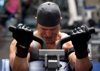 Staff Sgt. Ray Nealon, 735th Aircraft Maintenance Squadron crew chief, performs bicep curls at the gym Mar. 3 at Joint Base Pearl Harbor Hickam. Patrons of the gym can utilize the weight room as well as other facilities including a basketball court, cardiovascular exercise machines and a smoothie store. (U.S. Air Force photo by Staff Sgt. Nathan Allen)