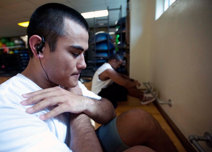 Two Air Force recruits perform sit ups at the gym Mar. 3 at Joint Base Pearl Harbor Hickam in preparation for their upcoming experience at basic military training at Lackland Air Force Base, Texas. Patrons of the gym can utilize the weight room as well as other facilities including a basketball court, cardiovascular exercise machines and a smoothie store. (U.S. Air Force photo by Staff Sgt. Nathan Allen)