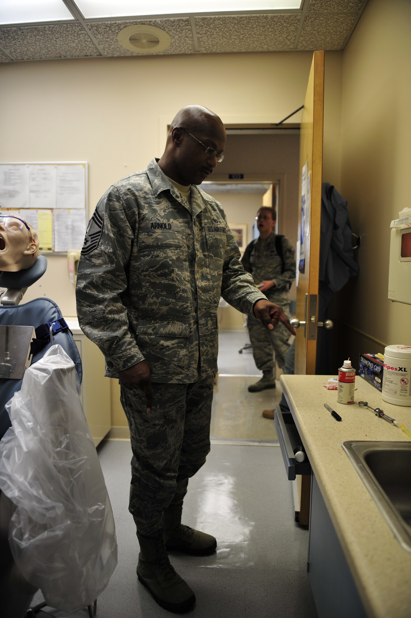 Chief Master Sgt. Kevin Arnold, 1st Special Operations Medical Group superintendent, points out some of the errors and potential hazards during the “Comedy of Errors” Unsafe Room Contest at the dental clinic at Hurlburt Field, Fla., March 7, 2011. The contest was part of the medical group’s third annual National Patient Safety Awareness Week, an effort focusing on the importance of being informed, involved and invested in committing to safe health care. (U.S. Air Force photo by Staff Sgt. Stephanie Jacobs / RELEASED)