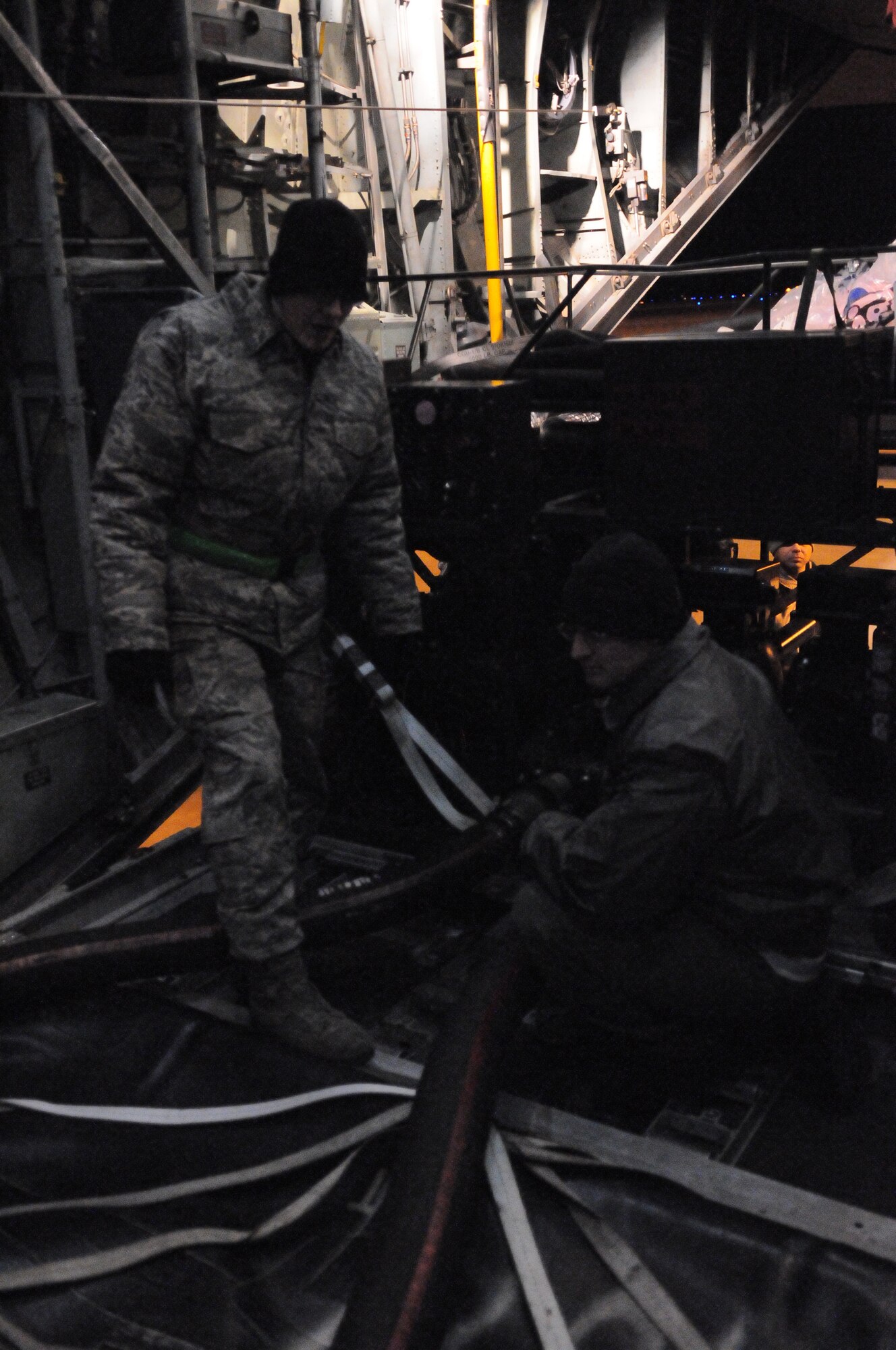MISAWA AIR BASE, Japan -- Staff Sgt. Michael Davidson and Staff Sgt. Thomas Montgomery, 35th Logistics Readiness Squadron, connect fuel pumps to fuel bladders here March 18. Yokota provided Misawa with fuel to allow the base to continue operations after the earthquake and tsunami left Misawa without power. (U.S. Air Force photo/Airman 1st Class Krystal M. Garrett)