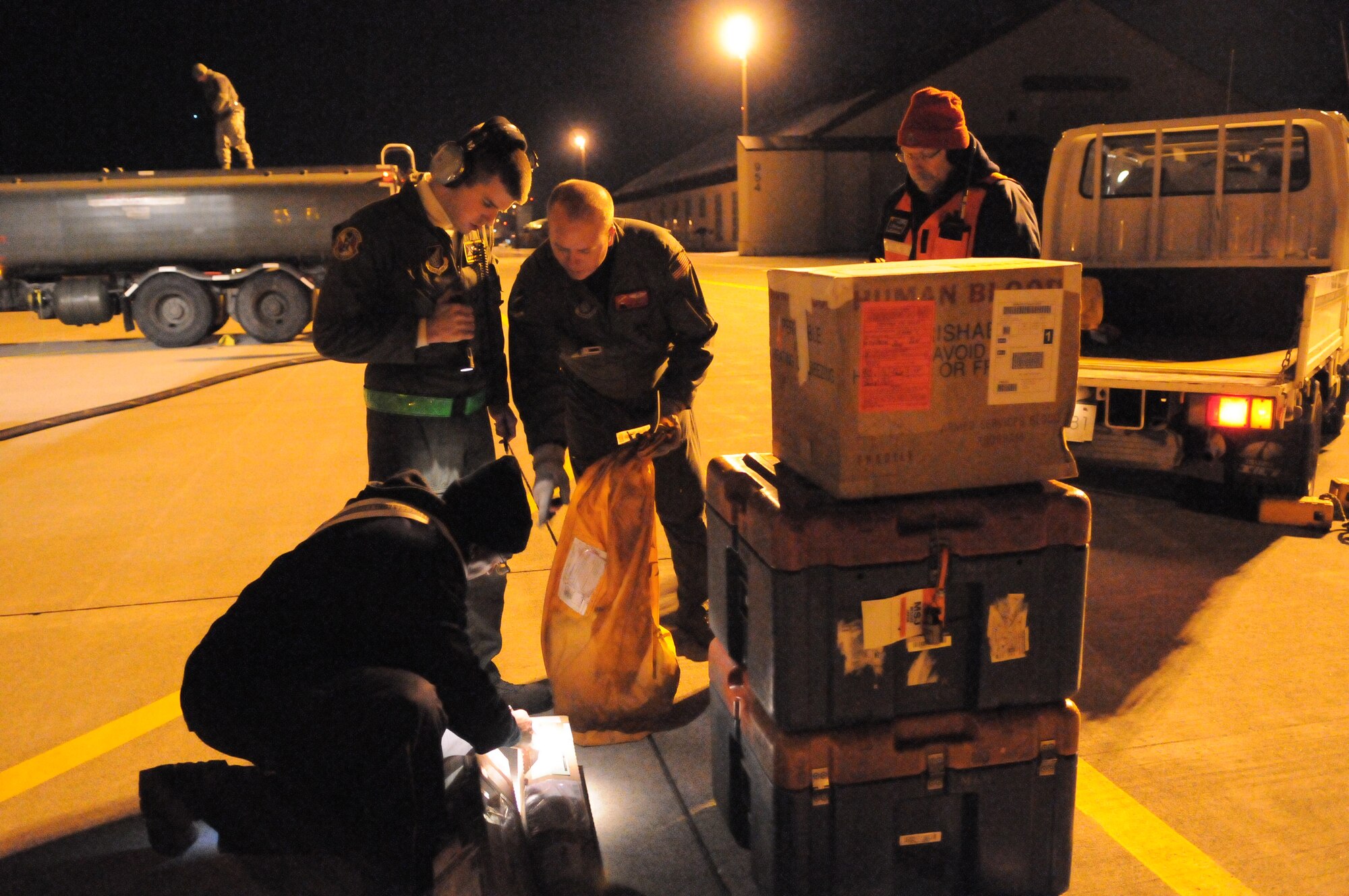 MISAWA AIR BASE, Japan -- Airmen from Yokota and Misawa unload blood, mail and fuel here March 18. Yokota supplied Misawa with fuel to allow the base to continue operations after the earthquake and tsunami. (U.S. Air Force photo/Airman 1st Class Krysatl M. Garrett)