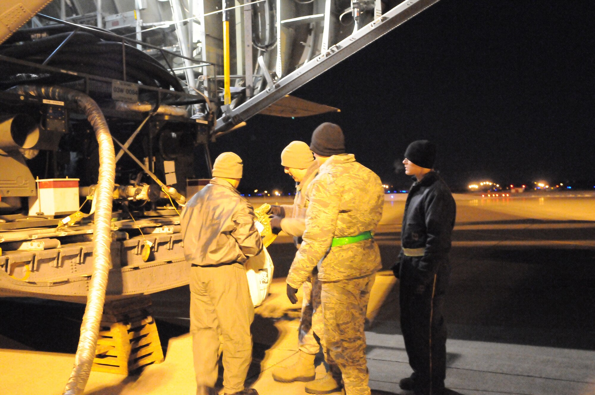 MISAWA AIR BASE, Japan -- Yokota and Misawa Airmen prepare to defuel bladders from a C-130 Hercules into an R-11 fuel truck here March 18. Yokota provides Misawa with fuel so that they can continue base operations after a power outage due to the earthquake and tsunami. (U.S. Air Force photo/Airman 1st Class Krystal M. Garrett