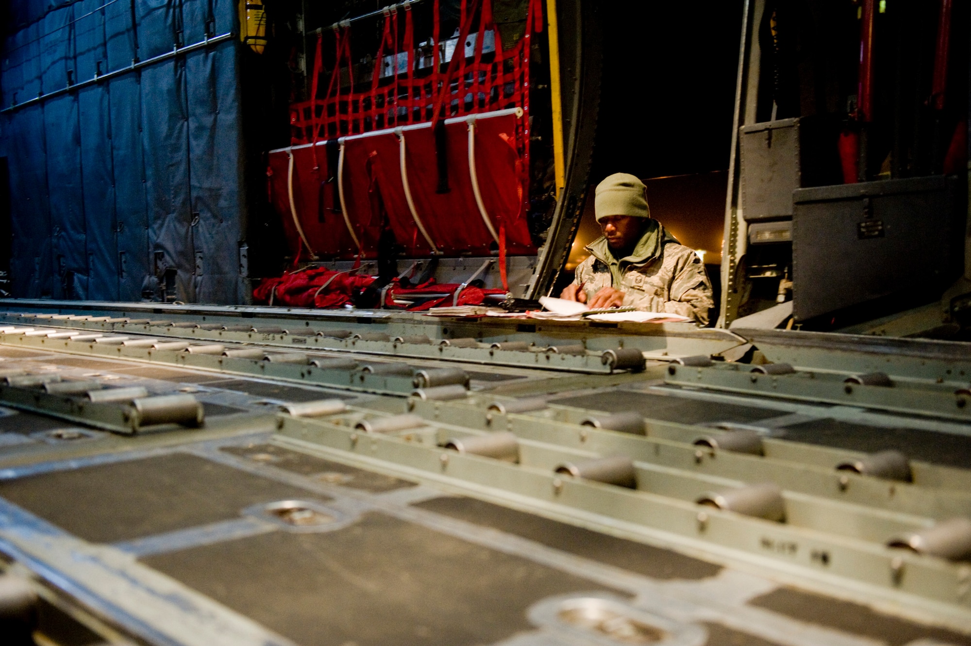YOKOTA AIR BASE, Japan -- Master Sgt. Marlin Sherwin, 374th Aircraft Maintenance Squadron, prepares paperwork on a C-130H Hercules prior to take-off here March 18. The 36th Airlift Squadron provided blankets to Sendai Airport in support of Japan's earthquake and tsunami relief effort. (U.S. Air Force photo/Staff Sgt. Jonathan Steffen)