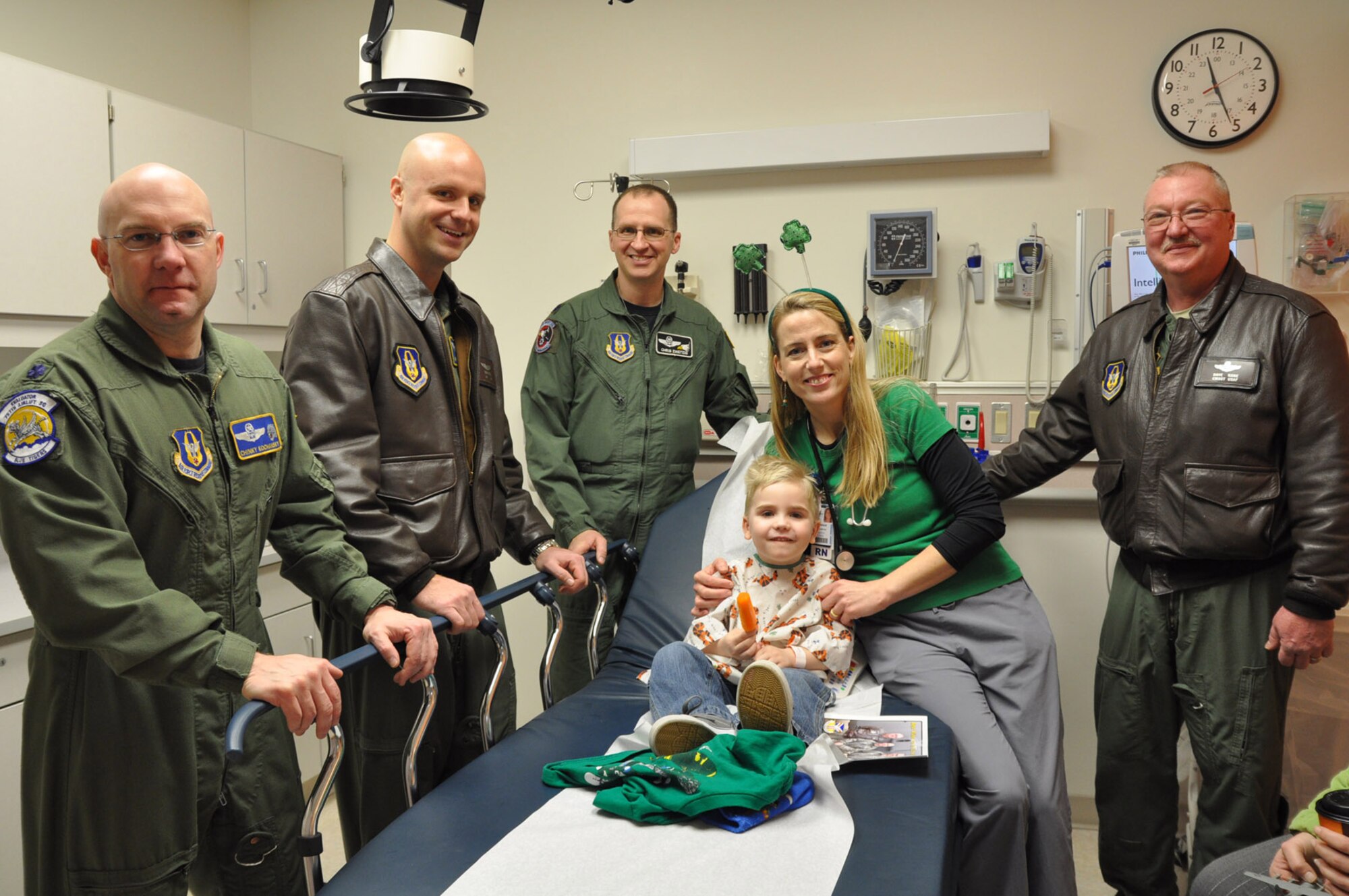 BOARDMAN, Ohio — Aircrew members from the Air Force Reserve's 910th Airlift Wing visit kids at Akron Children's Hospital of the Mahoning Valley on St. Patrick's Day, March 17.  Lt. Col. John Kochansky, Capt. Brian Hodor, Lt. Col.Chris Zweitzig, and Chief Master Sgt. David Kane stand near hospital staff member, Monique Malmer as she holds four-year old Michael Keyes of Leetonita.  Michael is a patient at the Boardman campus.  U.S. Air Force Photo/ Maj. Brent Davis