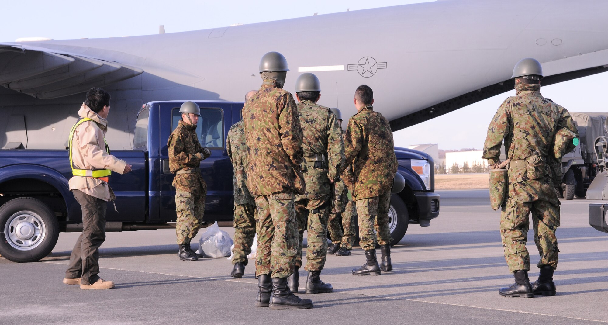 Japan Ground Self-Defense Force members arrive at Yokota Air Base, Japan from Okinawa, March 17, 2011. JGSDF service members will team with U.S. forces to provide support for earthquake and tsunami relief efforts. (U.S. Air Force photo/Airman 1st Class Krystal M. Garrett)