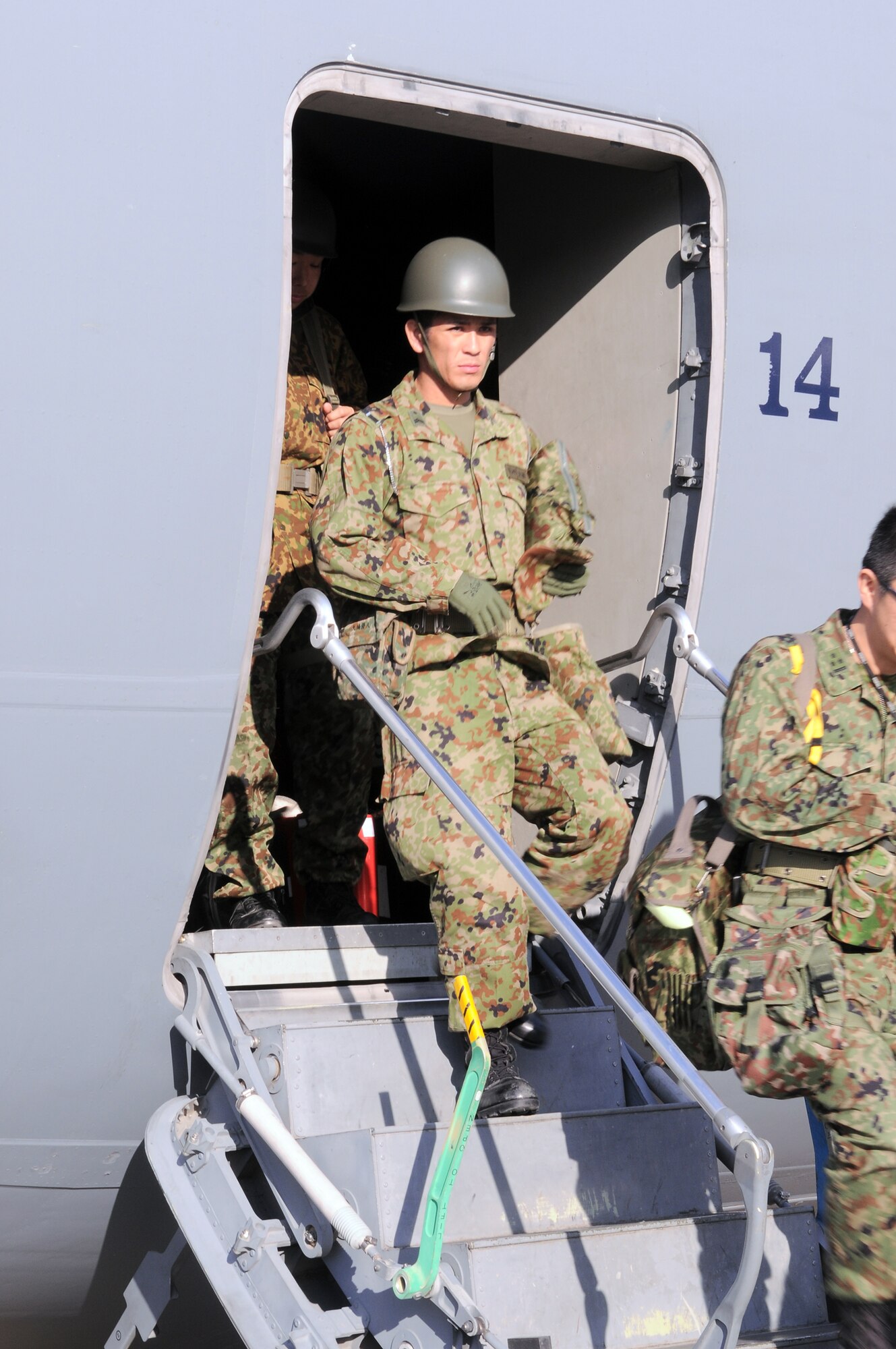 Japan Ground Self-Defense Force members disembark from the C-17 Globemaster III that transported them to Yokota Air Base, Japan, from Okinawa, March 17, 2011. JGSDF will team up with US forces to support earthquake and tsunami relief efforts. (U.S. Air Force photo/Airman 1st Class Krystal M. Garrett) 
