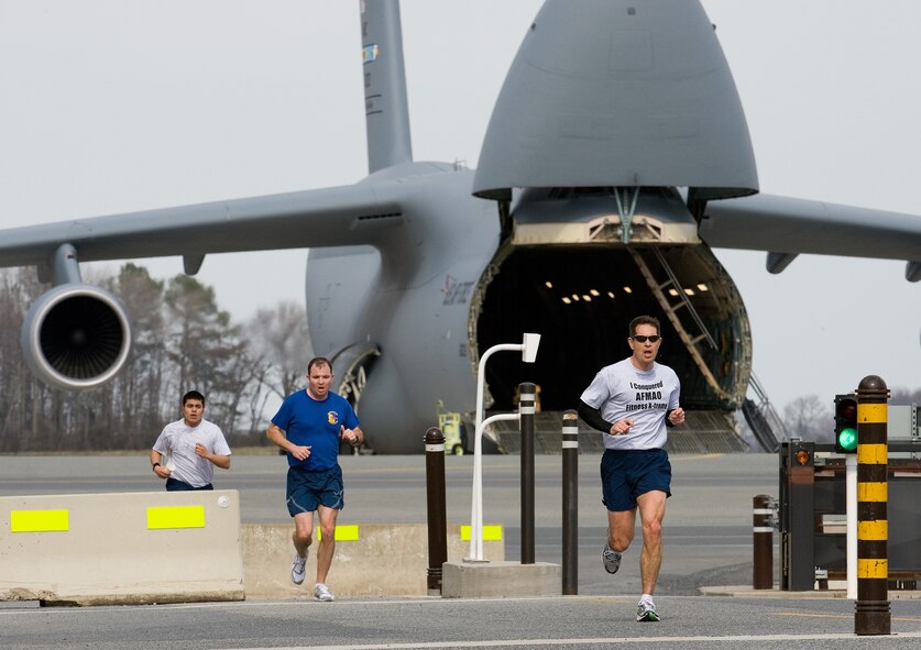 Col. Thomas C. Joyce, Air Force Mortuary Affairs commander, sports his "I conquered AFMAO Fitness X-treme" T-shirt as he crosses the finish line of a base  warrior run March 16, 2011. (U.S. Air Force photo/Jason Minto)