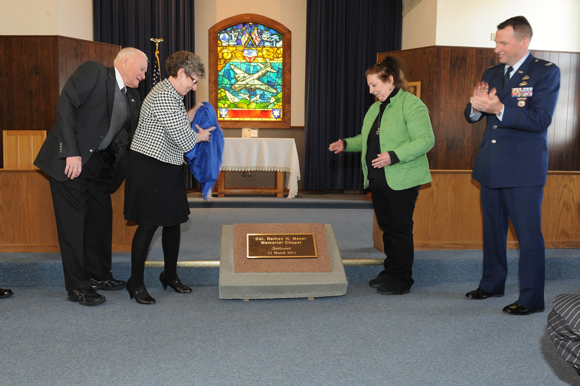 (Left to right) Lt. Gen. (Ret.) Marc Reynolds, president of the Aerospace Heritage Foundation, Harriet Mazer and Amy I. Meighan, daughters of Nathan Mazer for whom the chapel is now named, and Col. Patrick Higby, commander of the 75th Air Base Wing, unveil a plaque at the Mazer Memorial Chapel March 11. (U.S. Air Force photo by Alex Lloyd)