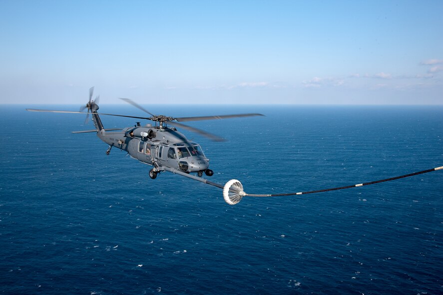 PACIFIC OCEAN -- An MC-130P Combat Shadow from the 17th Special Operations Squadron refuels a HH-60 Pave Hawk helicopter from the 33rd Rescue Squadron March 18. The refueling missions are in support of humanitarian relief operations after an 8.9 magnitude earthquake and following tsunami that rocked Northeastern Japan March 11. (U.S. Air Force photo/Osakabe Yasuo)