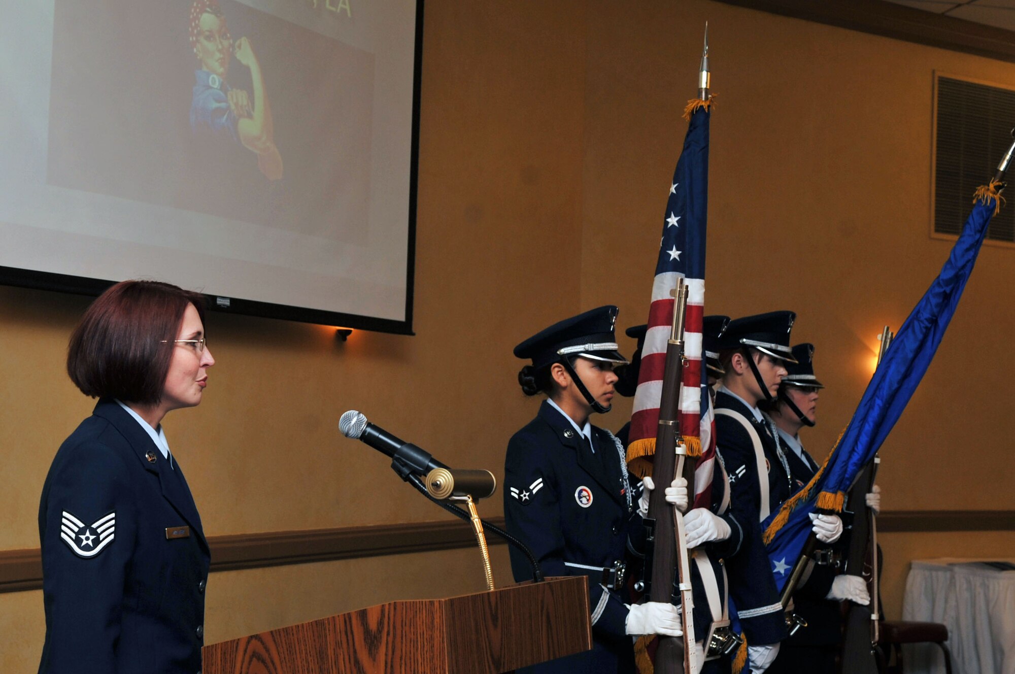Barksdale's Honor Guard presents the colors as Staff Sgt. Ruth Walker, 608th Air Communication Squadron, sings the National Anthem during the Women's Heritage Luncheon at Barksdale Air Force Base, La., March 15. This year's Women's History Month theme "Our History is our Strength." Women's History Month is commemorated March 1-31. The observance recognizes and celebrates the diverse and historic accomplishments of women throughout the world. (U.S. Air Force photo/Senior Airman Brittany Y. Bateman)(RELEASED)