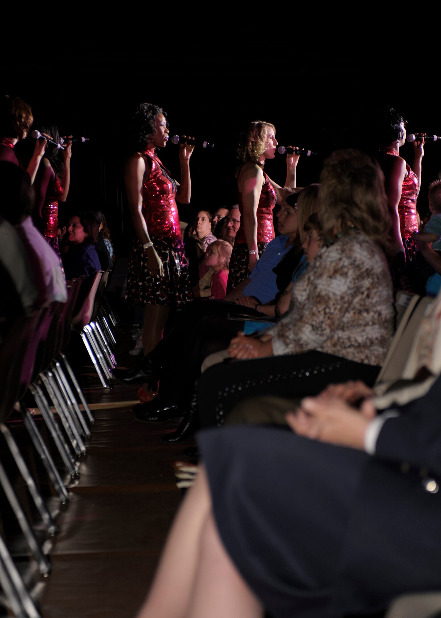 Tops in Blues performers walk amongst the crowd during their show at the Greyhound Arena in Portales, N.M., March 16, 2011.Tops in Blues is an U.S. Air Force entertainment troupe that entertains communities in more than 20 countries yearly. (U.S. Air Force photo by Airman Ericka Engblom)