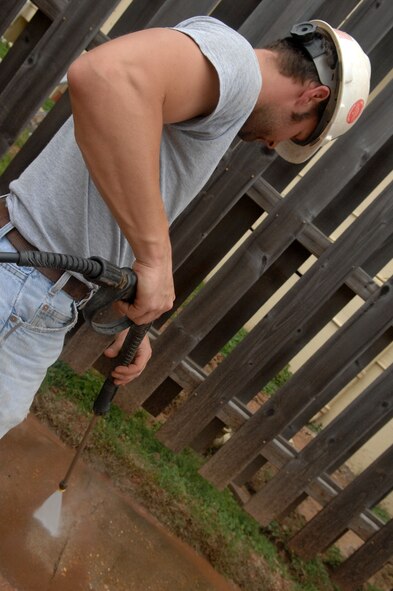 Matt Mays, base contractor, pressure washes the sidewalk of the 2nd Civil Engineer Squadron March 18 at Barksdale Air Force Base, La. Recent construction left the sidewalks covered in dirt. (U.S. Air Force photo/ Senior Airman Allison M. Boehm)(RELEASED)