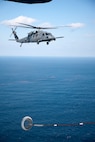 PACIFIC OCEAN -- An MC-130P Combat Shadow from the 17th Special Operations Squadron refuels a HH-60 Pave Hawk helicopter from the 33rd Rescue Squadron March 18. The refueling missions are in support of humanitarian relief operations after an 8.9 magnitude earthquake and following tsunami that rocked Northeastern Japan March 11. (U.S. Air Force photo/Osakabe Yasuo) 