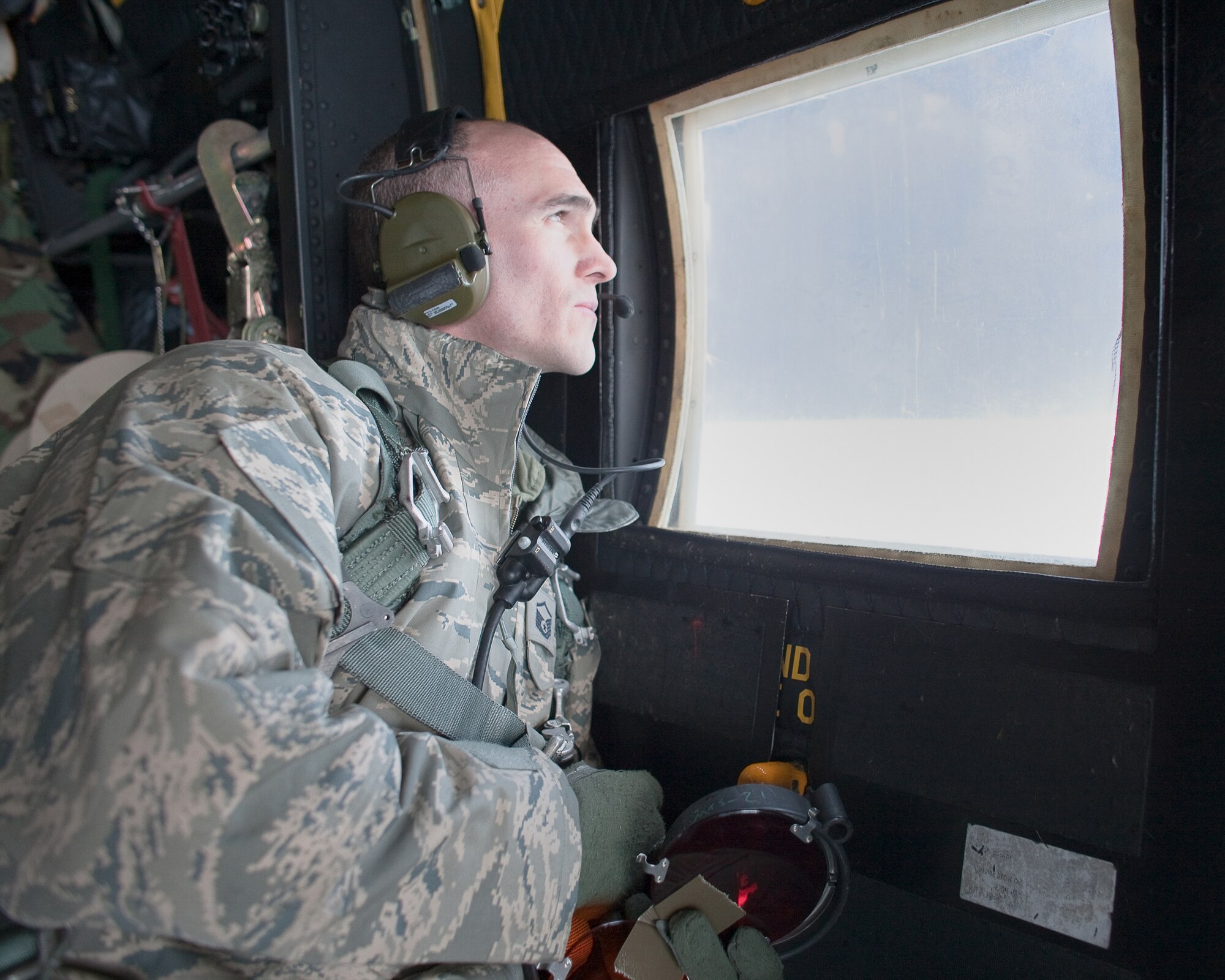 PACIFIC OCEAN -- Master Sgt. Michael Milich, a 17th Special Operations Squadron loadmaster, observes an HH-60 Pave Hawk helicopter from the 33rd Rescue Squadron during an aerial refueling March 18. The refueling missions are in support of humanitarian relief operations after an 8.9 magnitude earthquake and following tsunami that rocked Northeastern Japan March 11. (U.S. Air Force photo/Osakabe Yasuo)