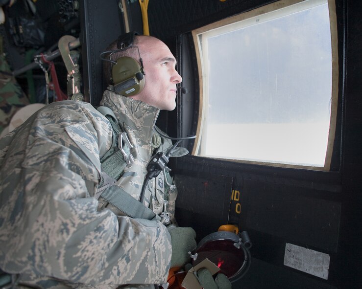 PACIFIC OCEAN -- Master Sgt. Michael Milich, a 17th Special Operations Squadron loadmaster, observes an HH-60 Pave Hawk helicopter from the 33rd Rescue Squadron during an aerial refueling March 18. The refueling missions are in support of humanitarian relief operations after an 8.9 magnitude earthquake and following tsunami that rocked Northeastern Japan March 11. (U.S. Air Force photo/Osakabe Yasuo)