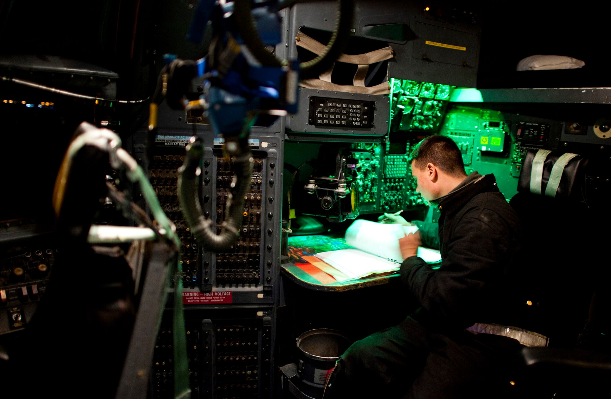 Airman 1st Class Stephen Tessier reviews log books while powering up a C-130 Hercules March 14, 2011, at Yokota Air Base, Japan. C-130s play a crucial role in disaster-relief operations because of their ability to land on dirt runways and other less-than-ideal landing conditions. Airman Tessier is a crew chief assigned to the 374th Aircraft Maintenance Squadron. (U.S. Air Force photo/Staff Sgt. Samuel Morse) 