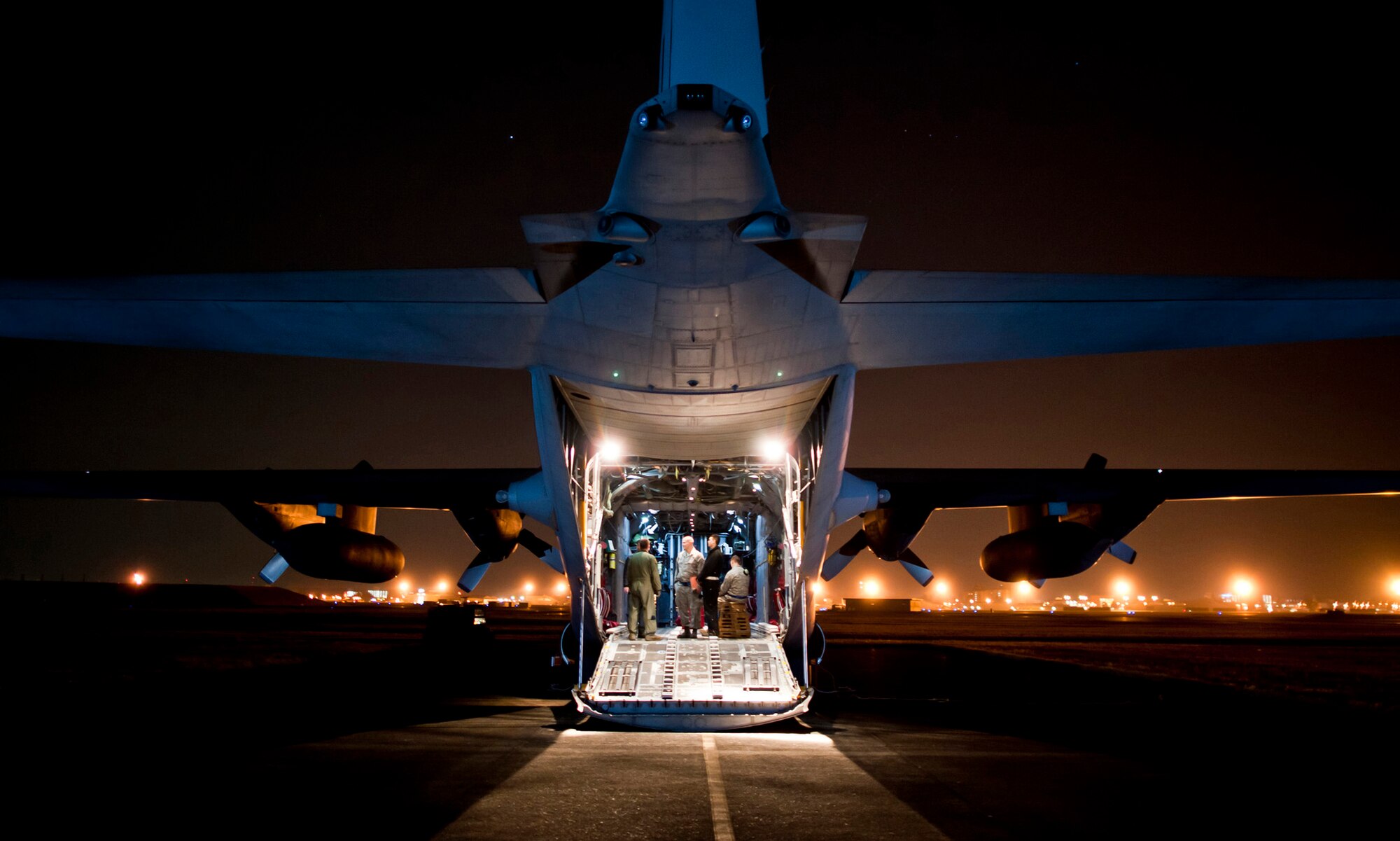 Maintainers from the 374th Aircraft Maintenance Squadron talk with loadmasters and flight engineers from the 36th Airlift Squadron while starting up a C-130 Hercules March 14, 2011, at Yokota Air Base, Japan. C-130s play a crucial role in disaster-relief operations because of their ability to land on dirt runways and other less-than-ideal landing conditions. (U.S. Air Force photo/Staff Sgt. Samuel Morse) 
