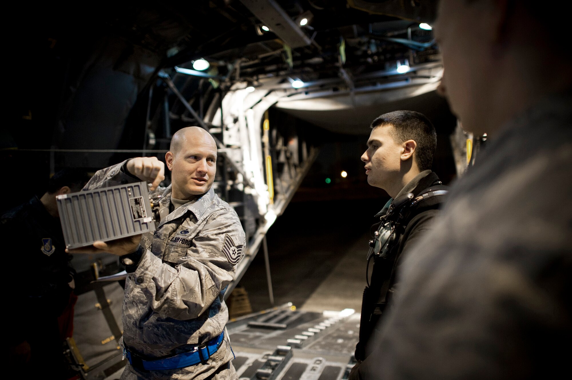 Tech. Sgt. Douglas Harper mentors Airmen about the differences between a receiver-transmitter and a generator control unit March 14, 2011, at Yokota Air Base, Japan. C-130s play a crucial role in disaster-relief operations because of their ability to land on dirt runways and other less-than-ideal landing conditions. Sergeant Harper is crew chief assigned to the 374th Aircraft Maintenance Squadron. (U.S. Air Force photo/Staff Sgt. Samuel Morse) 