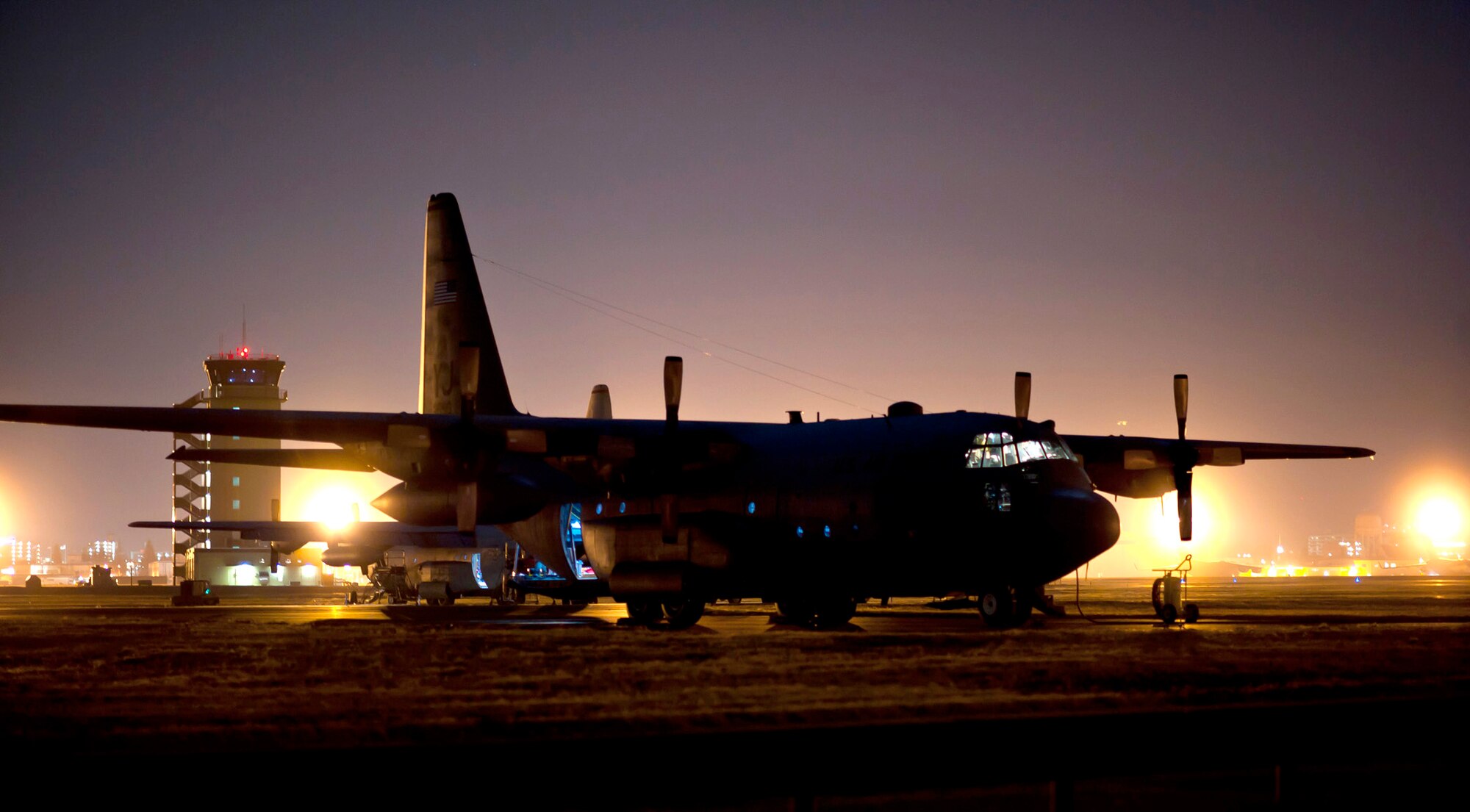 Maintainers from the 374th Aircraft Maintenance Squadron power up a C-130 Hercules for night-flying operations March 14, 2011, at Yokota Air Base, Japan. C-130s play a crucial role in disaster-relief operations because of their ability to land on dirt runways and other less-than-ideal landing conditions. (U.S. Air Force photo/Staff Sgt. Samuel Morse) 