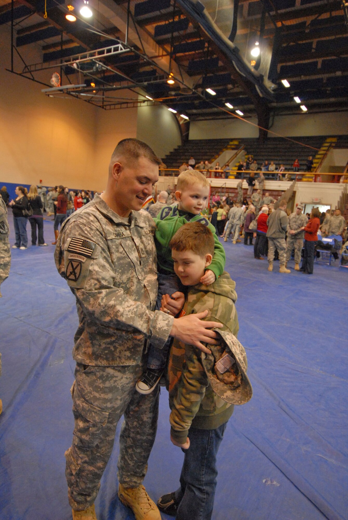 Sgt. 1st Class James Camba and sons Colton, 2, and Chandler, 9, at the deployment ceremony for the 164th Military Police, Monday, in Buckner Physical Fitness Center.  (U.S. Air Forec photo/Steve White)