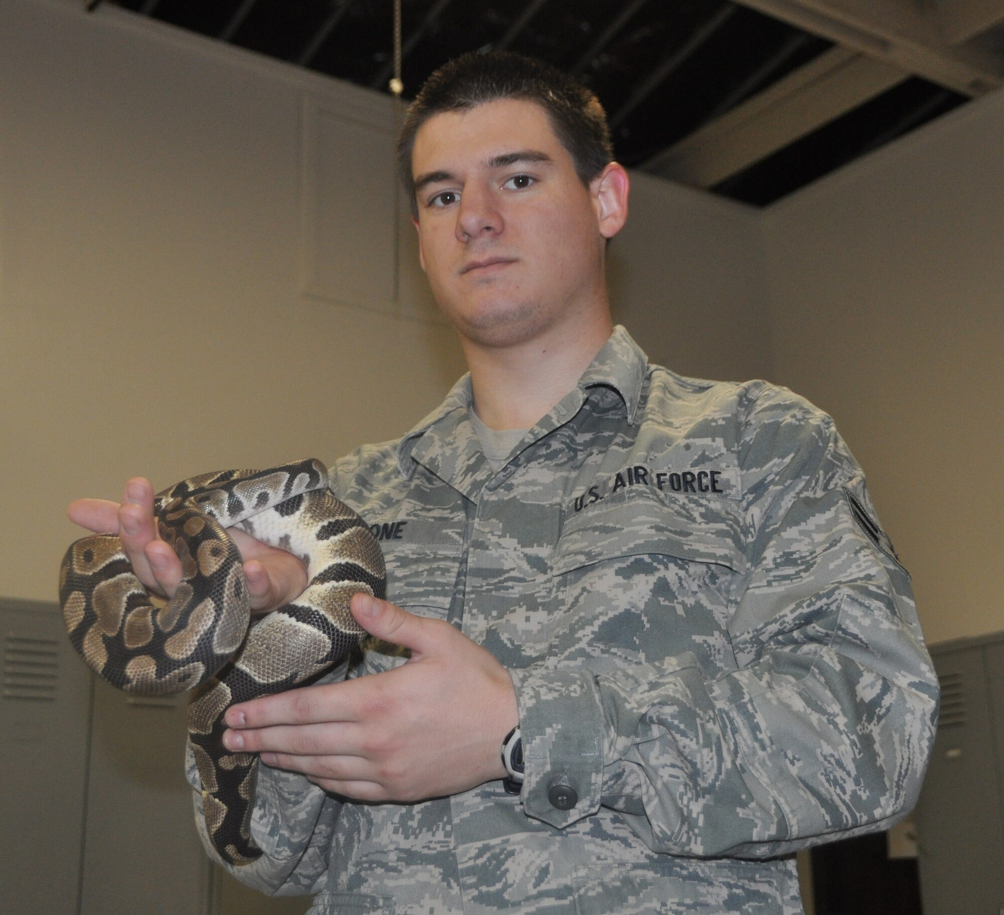 Airman 1st Class Dustin Stone practices handling a snake in the 60th Civil Engineering Squadron entomology shop. 
