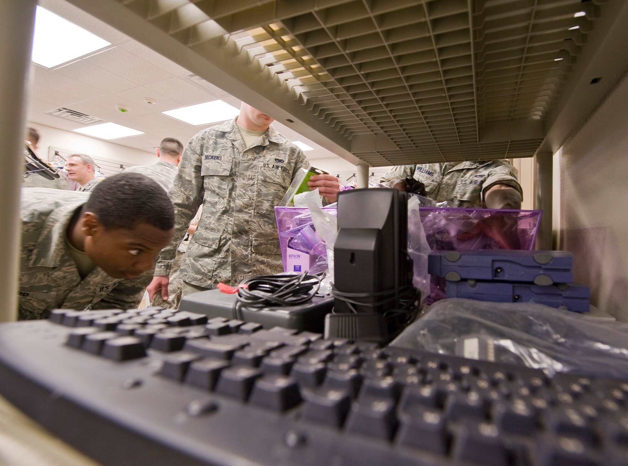 Airmen browse through merchandise during the reopening ceremony of the Airman's Attic on Barksdale Air Force Base, La., March 17. The Airman's Attic provides Airmen with secondhand merchandise donated by their peers free-of-charge. (U.S. Air Force photo/Senior Airman Chad Warren)(RELEASED)