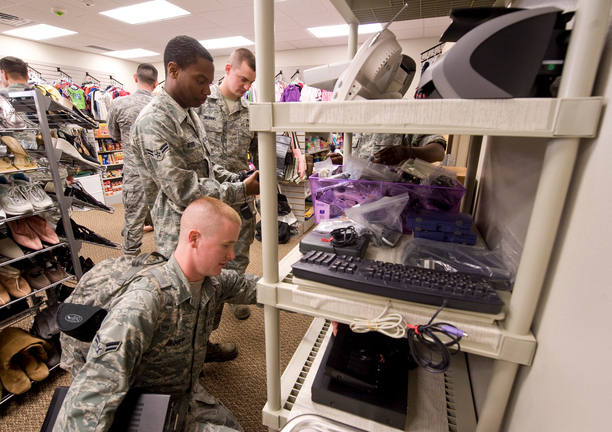 Airmen browse through merchandise during the reopening ceremony of the Airman's Attic on Barksdale Air Force Base, La., March 17. The Airman's Attic provides Airmen with secondhand merchandise donated by their peers free-of-charge. (U.S. Air Force photo/Senior Airman Chad Warren)(RELEASED)