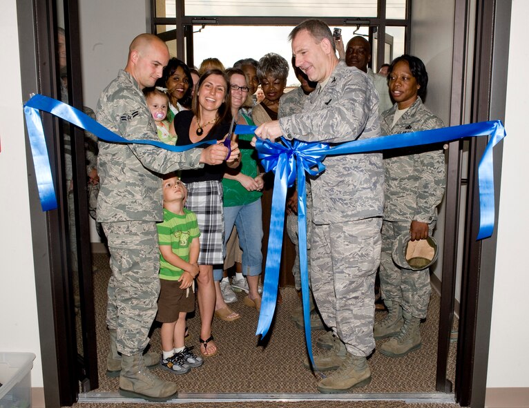 Airman 1st Class John Meyer, 2nd Aircraft Maintenance Squadron, and Col. Timothy Fay, 2nd Bomb Wing commander, cut the ribbon during the reopening ceremony of the Airman's Attic on Barksdale Air Force Base, La., March 17. Airman Meyer and his wife, Amanda, are regular volunteers at the Airman's Attic. (U.S. Air Force photo/Senior Airman Chad Warren)(RELEASED)