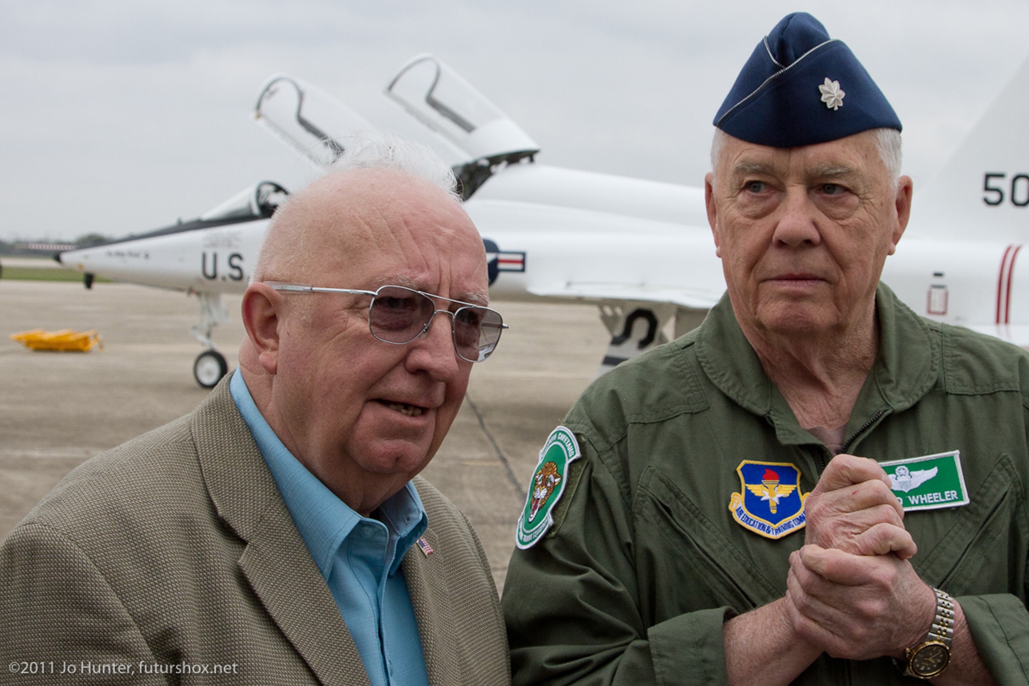 Retired Col. James Gibler (left) speaks with retired Lt. Col. Donald Wheeler March 17, 2011, at Randolph Air Force Base, Texas. In the background is a T-38 Talon. Colonel Wheeler was a member of the first class of pilots to train on the T-38. He graduated in 1962. Colonel Gibler was Colonel Wheeler's T-38 instructor. The two men had not seen each other for 49 years. This T-38 has been painted with a special commemorative color scheme, giving the plane an appearance similar to its original 1961 look. (Courtesy photo/Jo Hunter)