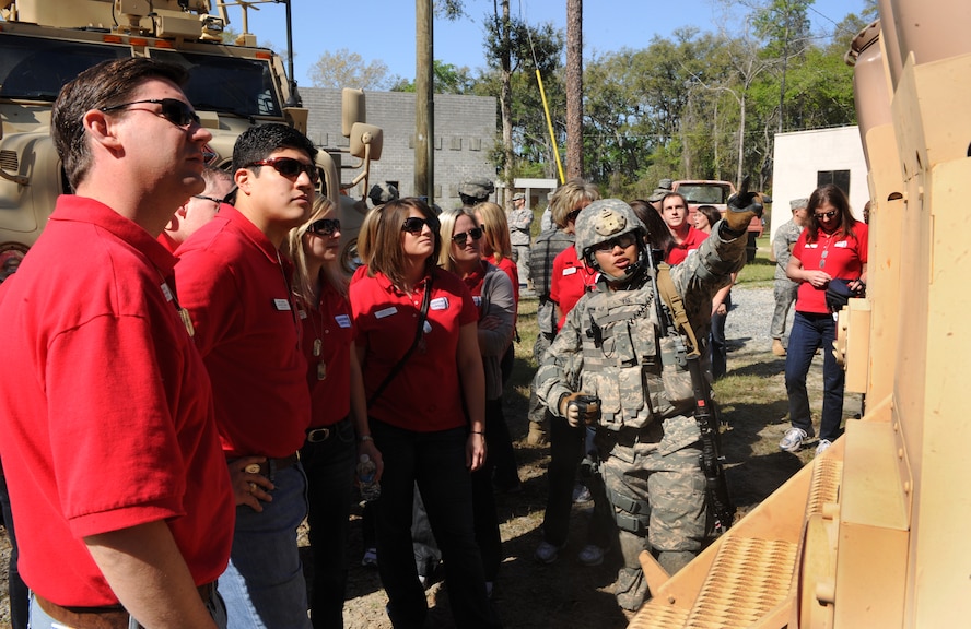 MOODY AIR FORCE BASE, Ga.-- Staff Sgt. Andrew Yu, 823rd Base Defense Squadron fire team leader, shows how the back door of an Mine Resistant Ambush Protected vehicle works to members of Leadership Lowndes during a base tour March 17. Each community leader toured the MRAP and was able to ask the 823rd BDS personnel questions during their visit. (U.S. Air Force photo/Airman 1st Class Benjamin Wiseman)(RELEASED)