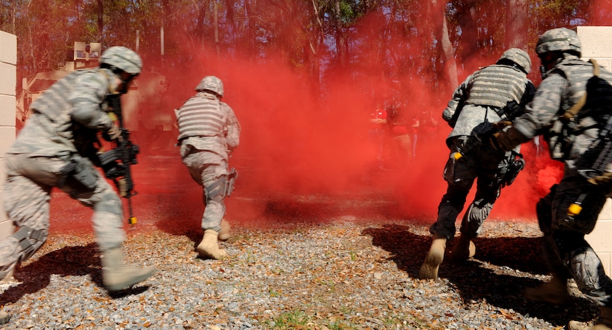 MOODY AIR FORCE BASE, Ga.-- Members of the 823rd Base Defense Squadron egress a mock village during a demonstration for Leadership Lowndes as part of their base tour March 17. Members from the 823rd BDS used smoke screens to conceal their movements during the demonstration. (U.S. Air Force photo/Airman 1st Class Benjamin Wiseman)(RELEASED)