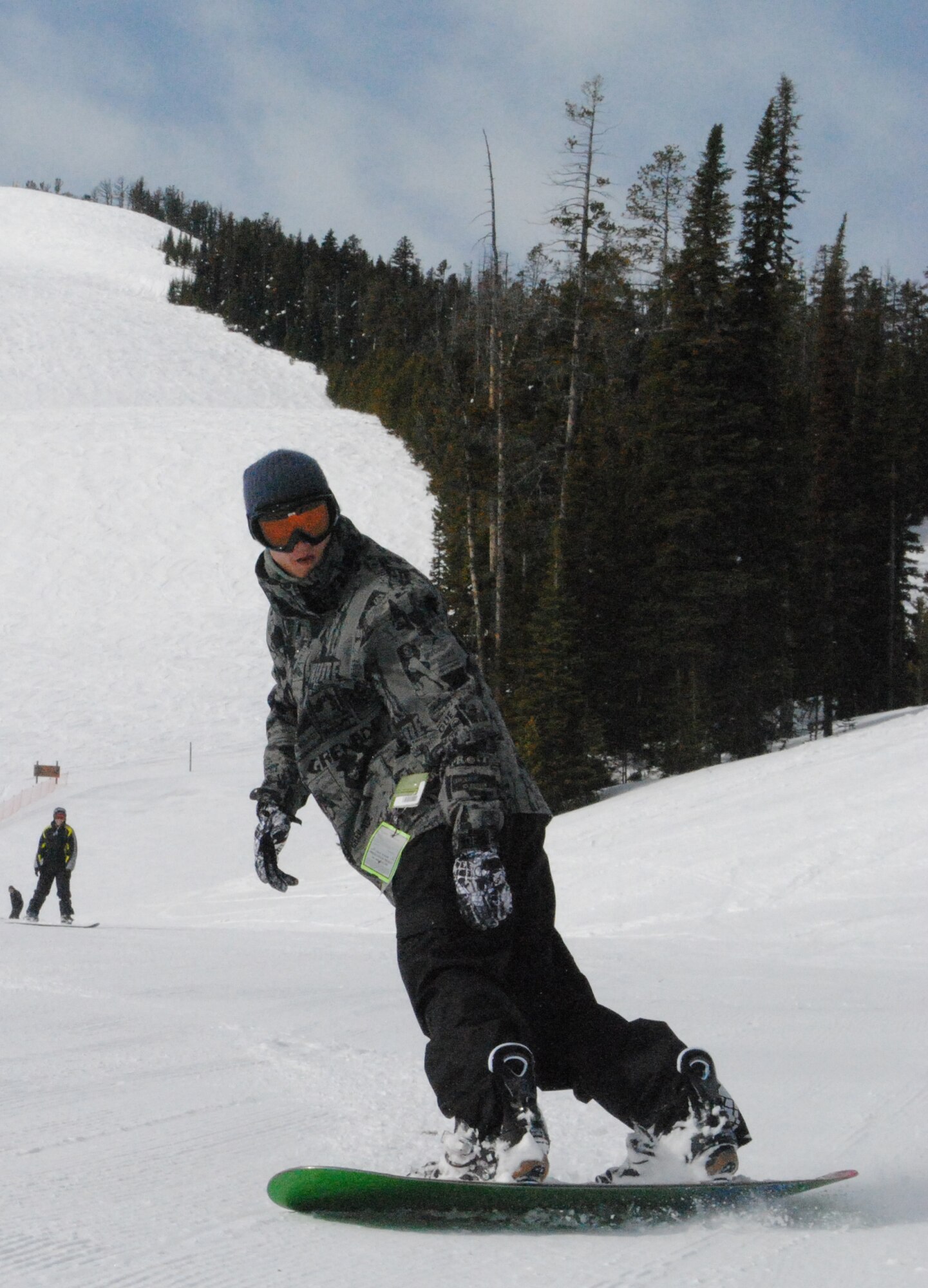 Senior Airman Jeffery Jones, a 341st Logistics Readiness Squadron material controller for vehicle maintenance, twists his board to help him slow down at the bottom of the slope.  He was one of many Airmen to attend Malmstrom's final Wing Ski Day at Showdown Ski Resort.  (U.S. Air Force photo/Airman Cortney Hansen)