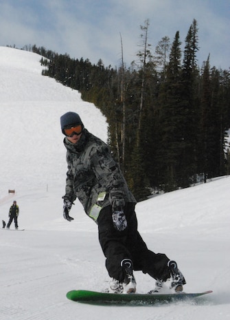 Senior Airman Jeffery Jones, a 341st Logistics Readiness Squadron material controller for vehicle maintenance, twists his board to help him slow down at the bottom of the slope.  He was one of many Airmen to attend Malmstrom's final Wing Ski Day at Showdown Ski Resort.  (U.S. Air Force photo/Airman Cortney Hansen)