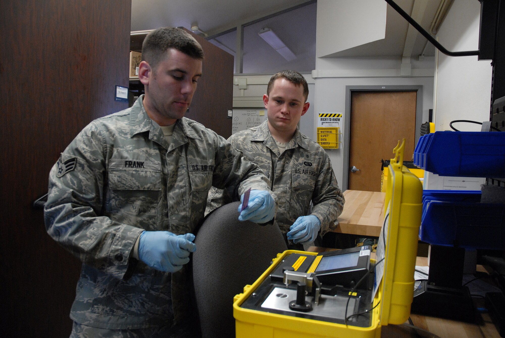 Senior Airman Rich Frank tests a package of beverage powder to demonstrate the identification capability of equipment at the Bioenvironmental building March 4. (U.S. Air Force photo/Staff Sgt. Dillon White)