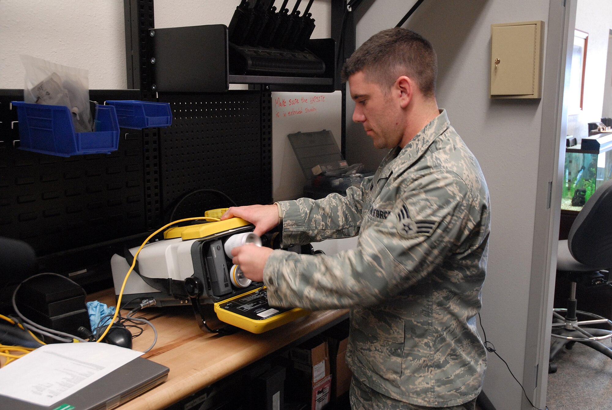 Senior Airman Rich Frank loads testing equipment with baseline gases to ensure it functions properly March 4 in the bioenvironmental building. (U.S. Air Force photo/Staff Sgt. Dillon White)