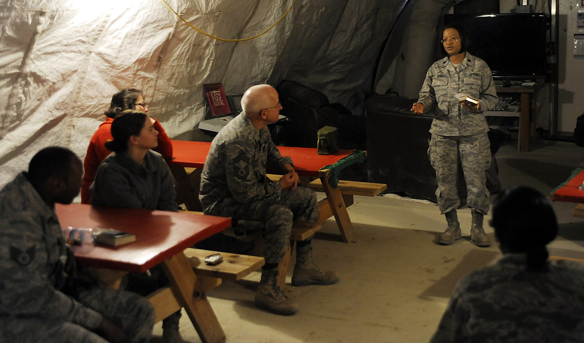 Lt. Col. Donnette Boyd performs 10 minute field service, March 12, 2011, at Kandahar Airfield, Afghanistan. Chaplain Boyd conducts these field services at three locations to maximize the number of Airmen she can reach. Chaplain Boyd is a Chaplain assigned to the 451st Air Expeditionary Wing. (U.S. Air Force photo/Senior Airman Willard E. Grande II)
